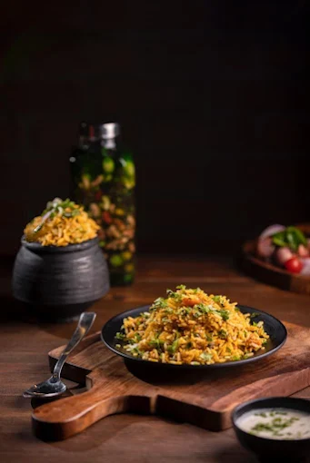 Vegetarian rice and noodle dish on a wooden board