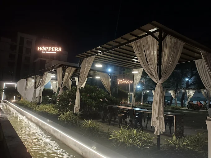 Hoppers outdoor seating and entrance at night
